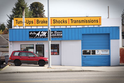 The marquee across the front of our building on Rucker Avenue, reading Tune-Ups, Brake, Shocks, Transmissions.
